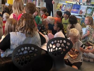 Billede af børn og voksne der får læst højt.